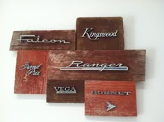 four wooden signs with different types of logos on them