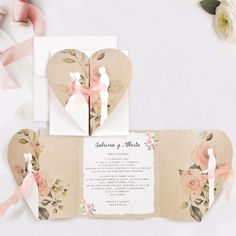 wedding stationery with flowers and hearts on the front, back and inside of it