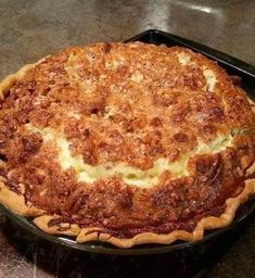 a pie sitting on top of a black pan