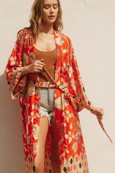 Discover the ultimate in comfort and style with our Sahara Kimono. Featuring a stunning paisley border print, this long duster adds an elegant touch to any outfit. The open front, side pockets, and side splits make it both functional and fashionable. Lightweight and fun, it's the perfect addition to your wardrobe. Paisley Border, Beach Cardigan, Long Duster, Denim Outerwear, Side Splits, Faded Denim, Graphic Tops, Floral Kimono, Border Print