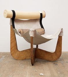 a chair that is sitting on top of a hard wood floor and has a piece of cloth draped over it