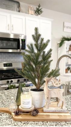 a small christmas tree sitting on top of a wooden tray