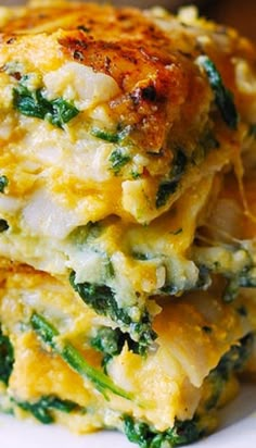 there are three pieces of food stacked on top of each other with cheese and spinach