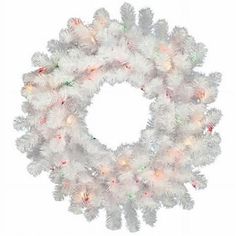 a white christmas wreath with lights on it