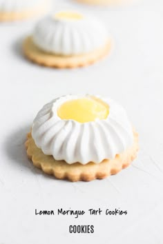 some cookies with icing on them sitting on a white counter top next to each other