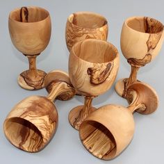 a group of wooden wine goblets sitting next to each other