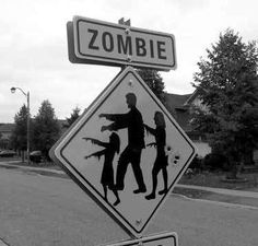 a black and white photo of a zombie crossing sign