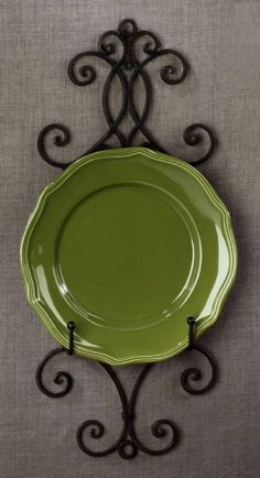 a green plate sitting on top of a metal rack