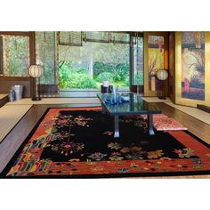 The LoomBloom Chinese Art Deco rug, originating from India, features a bold black inner field bordered by a rich peach frame. Its surface is decorated with lush botanical and floral motifs in vibrant shades of mint, pink, navy, red, and ivory. Chinese Art Deco, Deco Rug, Art Deco Rug, Bold Black, Floral Botanical, Rug Store, Chinese Art, Rugs Online, Floral Motif