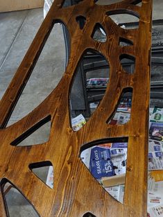 a wooden bench made out of magazines on the ground