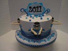 a blue and white birthday cake with an alien on the top is decorated with numbers