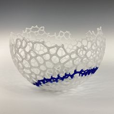 a white and blue bowl sitting on top of a table