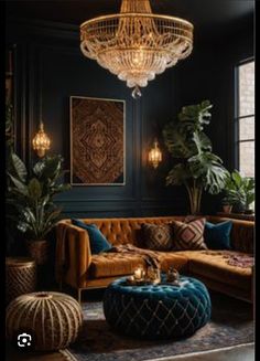 a living room filled with furniture and a chandelier hanging above the couches