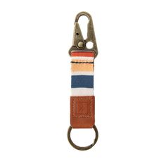 an orange, white and blue striped keychain with a metal hook on it