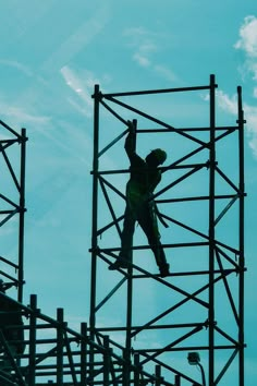 a man on a scaffold high up in the sky