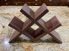 a wooden shelf sitting on top of a granite counter