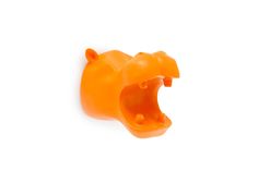 an orange plastic object that looks like a bear's head with its mouth open