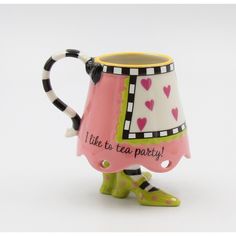 a pink and black coffee mug with hearts on it's side that says, i like to tea party