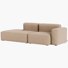 a beige couch sitting on top of a white floor