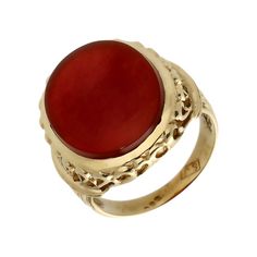 a gold ring with a red stone in it