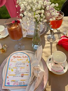 a table topped with plates and glasses filled with drinks