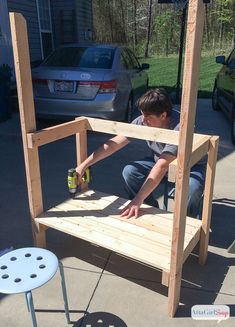 a young boy is working on a bench made out of wood