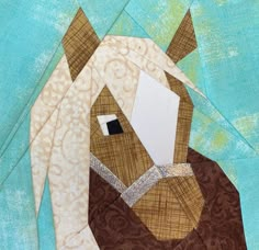 a close up of a horse's head made out of paper and fabric on a blue background