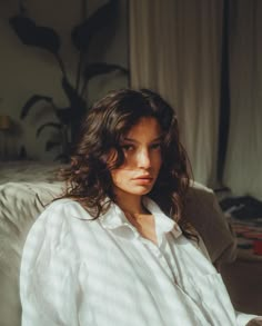 a woman sitting on top of a white couch