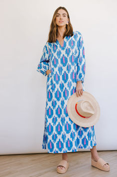 The Truman Ikat Sienna Dress fully embraces the colors of spring with a bold blue and vibrant pink in an exciting ikat print. The Sienna Dress is your classic summer kaftan (with pockets!). The unlined dress (but not see-through) has a perfectly cut side slit, and flattering plunge v-neck, making this a breezy dress for even the hottest of days. Dress runs oversized; size down if you want a more fitted look.  For dress length reference, the model is 5'10; the kaftan will hit at ankles on most. Summer Caftan, Sienna Dress, Summer Kaftan, Sarong Dress, Breezy Dress, Ikat Print, Maxi Styles, Bubble Sleeve, Caftan Dress