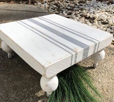 a white table with some grass on it