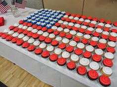 an american flag made out of cupcakes on a table