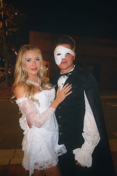 a man and woman dressed up in costumes