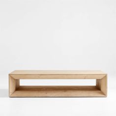 a wooden shelf sitting on top of a white wall