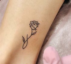 a small rose tattoo on the ankle