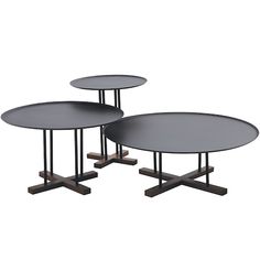 three round tables sitting on top of each other in different sizes and colors with metal bases