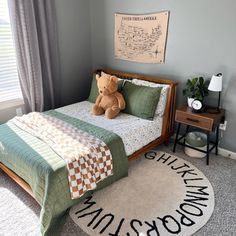 a teddy bear sitting on top of a bed in a bedroom