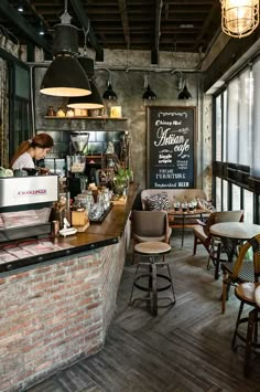 the interior of a restaurant with brick walls