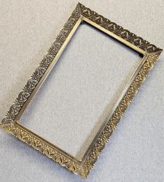 an ornate silver frame sitting on top of a table