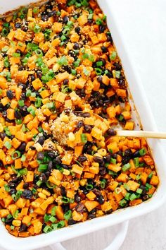 a casserole dish filled with sweet potatoes and black beans