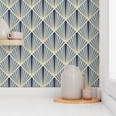 a blue and yellow wallpaper with white vases on the shelf next to it