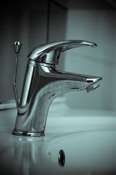 a chrome faucet sitting on top of a bathroom sink