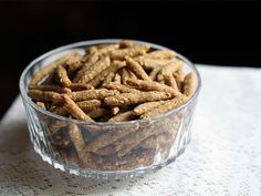 a glass bowl filled with dog treats on top of a table