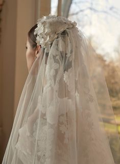 a woman wearing a veil with flowers on it