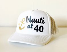 Nauti at 40! This is a fun hat for your favorite 40 year old and the Nauti Crew hats are perfect for her crew!! *this is an adult size trucker hat I welcome custom requests ~ please convo me to work out your own design! :: Hat Details :: - 100% Polyester Front - 100% Nylon Mesh Back - 5-panel cap - Seamless Foam Front Panel with Lining - Matching Mesh Color Braid - 8 Rows Stitching on Visor - Matching Fabric Undervisor - Matching Color Sweatband - Plastic Adjustable Snap White Snapback Party Hat, White Snapback Trucker Hat For Party, White Snapback Hat For Party, White Nautical Cap, White Summer Party Trucker Hat, White Novelty Party Hat, Customizable Adjustable Party Hats, Gold Summer Hats As Gifts, Gold Summer Hat As Gift