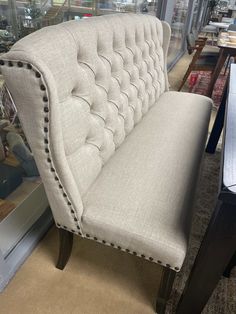 a white couch sitting on top of a wooden table