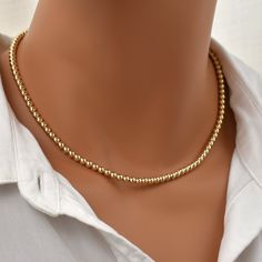 Gold Bead Necklace. Gold Beaded Choker. Layering Necklace. 4mm Beads. Smooth, luminous gold beads create a feeling of pure luxury. Timeless, simple, elegant, yet striking. This necklace goes with everything in your wardrobe, is easy to dress up or down, and makes a great gift. What is Gold Filled? Gold filled jewelry has a layer of solid gold that is 100 times thicker than that of gold plated jewelry. It is hypoallergenic, resistant to tarnish, and will not chip or fade over time. Gold filled has an appearance nearly identical to solid gold, but with a more affordable price. It is highly durable and with proper care will last a lifetime. Browse my shop: ALLDANAE.etsy.com Gold Rondelle Beaded Necklaces, Gold Dainty Rondelle Beaded Necklaces, Gold Rondelle Beaded Necklace Single Strand, Classic Gold Beaded Necklaces, Classic Gold Beaded Necklace, Gold Beaded Necklaces For Jewelry Making (8mm Beads), Yellow Gold Beaded Necklace With 8mm Round Beads, Gold Rondelle Beaded Necklaces With Spacer Beads, Simple Gold Necklaces