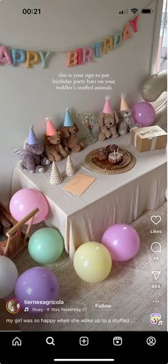 an image of a birthday party with balloons and teddy bears on the table in front of it