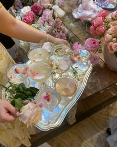 a table topped with lots of glasses and flowers