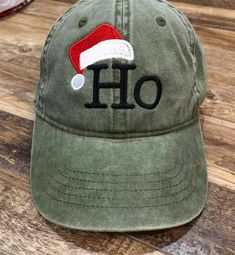 Fun Holiday, Christmas hat with Ho and Santa Hat. Available in green and black, Please specify when ordering. Baseball Santa, Christmas Baseball, Holiday Hats, Embroidery Christmas, Hat Embroidery, Hat Ideas, Embroidered Baseball, Embroidered Baseball Caps, Embroidered Caps