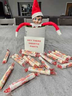 an elf is sitting on the floor with many candy bars in front of him and there is a sign that says hey there is no more than dynamites